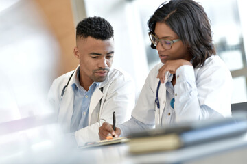 Young doctors working on laptop at the hospital