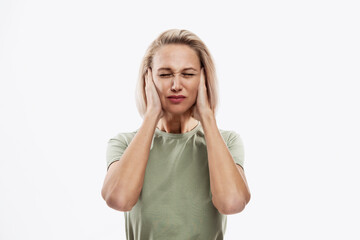 Fototapeta premium Young blond woman holding her head. Headache, problems and stress. Isolated on white background.