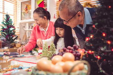 Thanksgiving or christmas Celebration Asian  Family Dinner Concept.Happy family having holiday dinner. father mother and daughter, having dinner at home. elderly parents during the celebration .