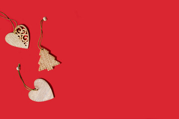 red christmas background with wooden toys heart. flat lay for new year