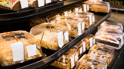 variety of sweet delicious cakes on the shop window of a cafe
