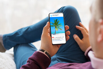 Man looking at beautiful photos posted on social media