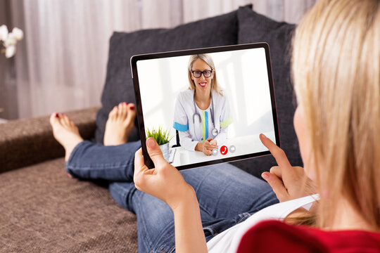 Woman Talking With Doctor On Video Call On Tablet