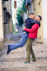 Gay couple in a fun and romantic moment in the street.