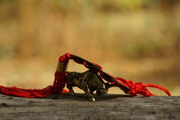 Metal bull figurine with Chinese coins close-up.