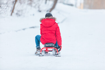 Lviv, Ukraine - January 5, 2019: kids sliding from snowed hill
