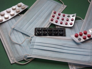 Medical masks and pills close up