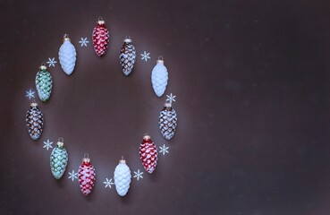 christmas wreath made with christmas ornaments on dark background