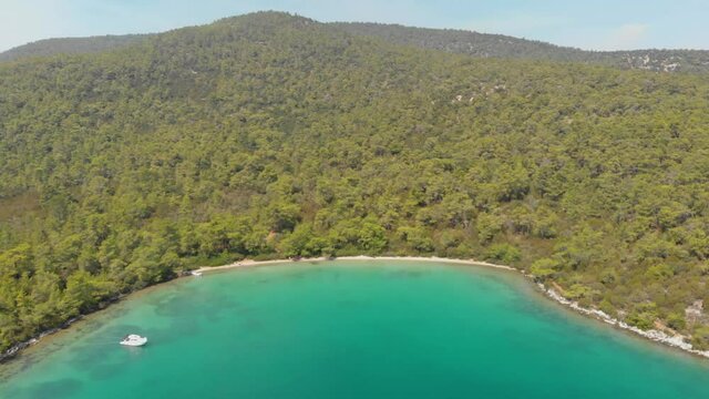 Aerial nature landscape of secret bay of Aegean Sea where green and blue meets. Pure nature with incredible clear green waters on a summer day in Didim, Turkey