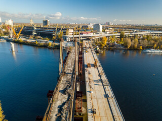 Naklejka premium Bridge construction site in Kiev. Sunny autumn morning. Aerial drone view.