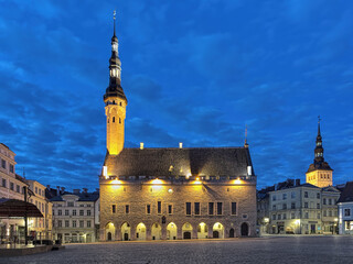 Tallinn Town Hall on the Town Hall Square and tower of the St. Nicholas' Church  at dawn, Estonia