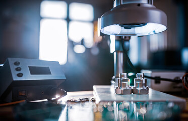 Modern microscope, connectors component and large green microcircuit in workshop laboratory
