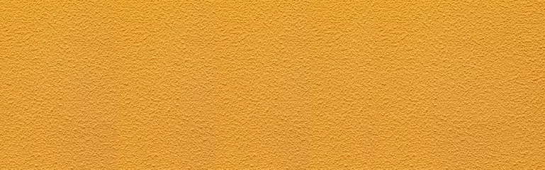 Fotobehang Panorama of The walls of the cement building are painted in yellow with rough patterns background seamless and texture © torsakarin