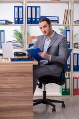 Young male employee businessman at workplace