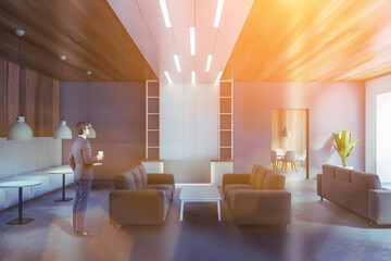 Man in gray and wooden waiting room