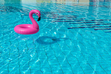 Flamingo icon. Pink inflatable flamingo in pool water for summer beach background. Trendy summer...