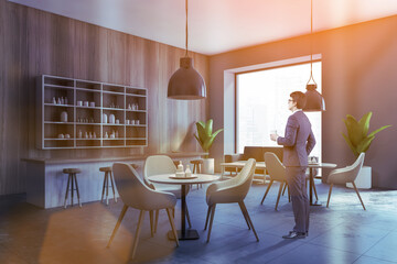 Man standing in wooden bar