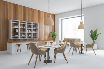 Grey cafe with chairs and wooden table with pendant lamps, wooden wall and grey floor