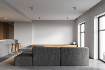 White and wooden kitchen interior with bar and sofa