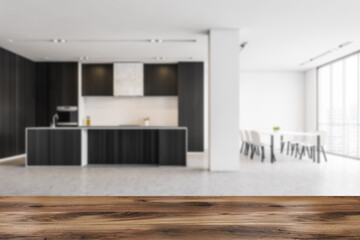 Grey open space kitchen in living room, wooden foreground in studio apartment