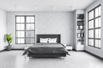 Grey bedroom with bed and linens, grey walls and window with a city view
