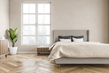 Wooden bedroom with bed and linens, beige walls and window with a city view