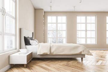 Wooden bedroom with bed and linens, beige walls and window with a city view