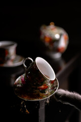 the cat drops the tea cup