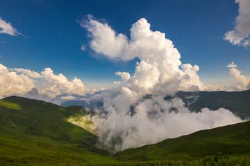Beautiful mountain landscape at Caucasus mountains with clouds and blue sky