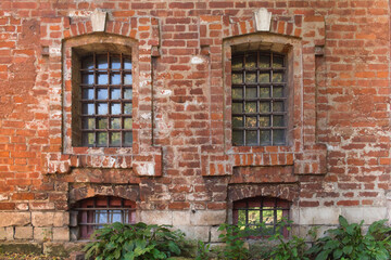 Fototapeta na wymiar Old brick wall of the monastery with two windows
