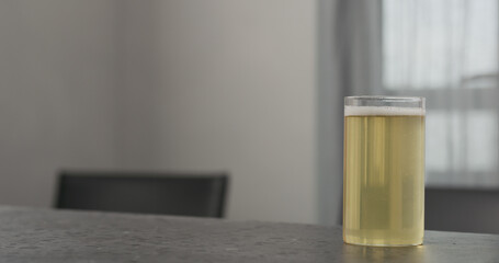 kombucha highball glass on concrete countertop with copy space