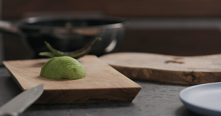 sliced avocado on olive wood board