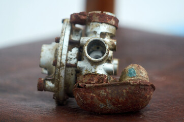 Photo of rusty carburator from chainsaw