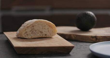 sliced ciabatta on olive board on kitchen countertop