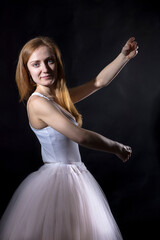Fototapeta premium Young beautiful woman in a tutu studio portrait.