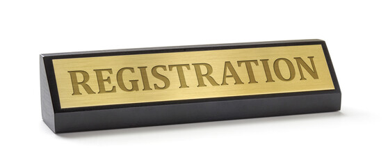 A name plate on a white background with the engraving Registration