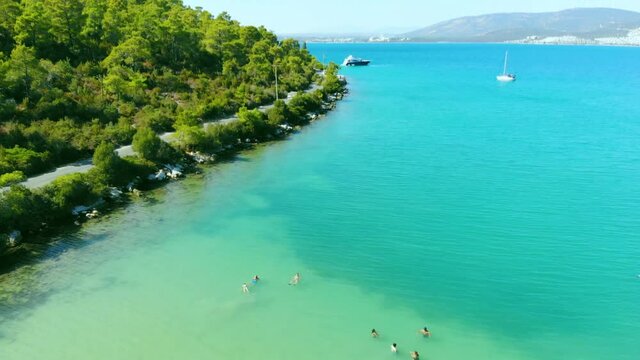 Aerial landscape of green bay of Akbuk with sail boat parking at the middle of Aegean sea in Didim, Turkey