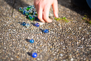 Playing marbles, old children's game, colorful balls