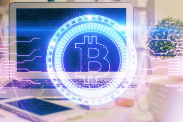 Multi exposure of blockchain and crypto economy theme hologram and table with computer background. Concept of bitcoin cryptocurrency.