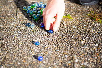 Playing marbles, old children's game, colorful balls