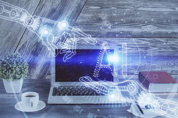 Double exposure of desktop computer and technology theme hologram. Concept of software development.