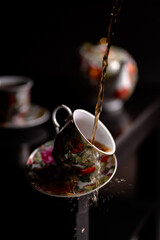 Naklejka na ściany i meble a cup of tea falling from the table