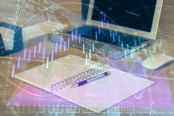 Double exposure of graph and financial info and work space with computer background. Concept of international online trading.