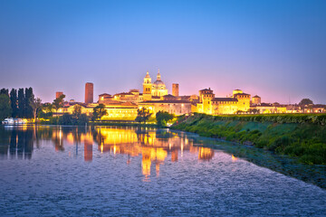 Naklejka na ściany i meble City of Mantova skyline lake reflections dawn view