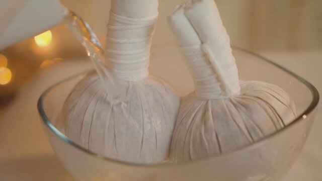 Herbal massage bags. Luk Pra Kob. Relaxing procedure. Exotic massage.