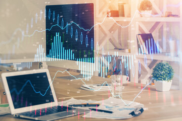 Financial graph colorful drawing and table with computer on background. Multi exposure. Concept of...