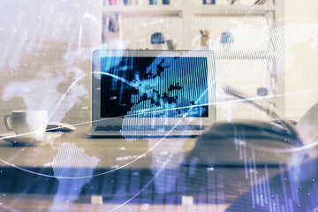 Financial chart drawing and table with computer on background. Double exposure. Concept of...
