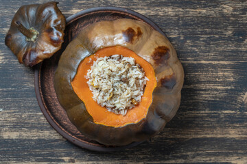 Stuffed roasted pumpkin, whole baked, filled with a mixture of rice, raisins and spices
