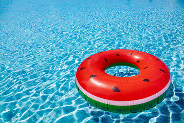 Inflatable watermelon buoy swim in the swimming pool view with perspective