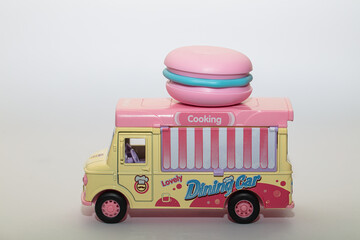 colorful toy food truck with pink macaron